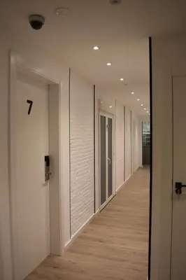 a row of doors in a hallway with wood floors at Casp Green House in Barcelona