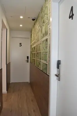 a hallway with a door with the number on the wall at Casp Green House in Barcelona