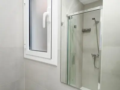 a bathroom with a glass shower with a mirror at Sitges with pool near beach by Hello Homes Sitges in Sitges