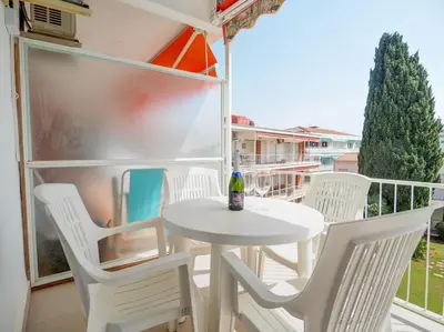 a white table and chairs on a balcony at Sitges with pool near beach by Hello Homes Sitges in Sitges