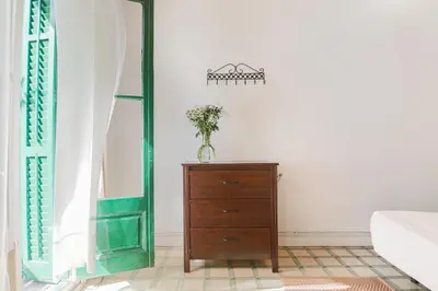 a bedroom with a dresser and a green door at Be Barcelona Eixample Universidad in Barcelona