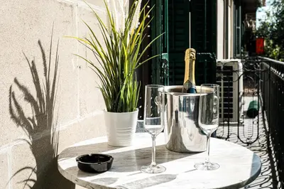 a table with two wine glasses and a bottle at Be Barcelona Eixample Universidad in Barcelona