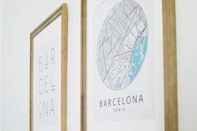 a framed picture of a barbaraota sign next to a mirror at Be Barcelona Eixample Universidad in Barcelona