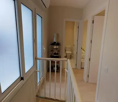 a hallway with a staircase leading to a bathroom at BARCELONA DUPLEX DE 3 HABITACIONES in Hospitalet de Llobregat