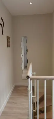 a stairway with a mirror on the wall at BARCELONA DUPLEX DE 3 HABITACIONES in Hospitalet de Llobregat