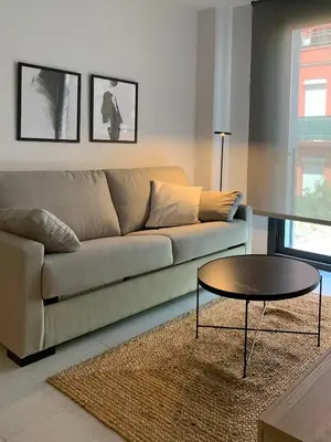 a living room with a couch and a coffee table at Topdown Apartments in Hospitalet de Llobregat