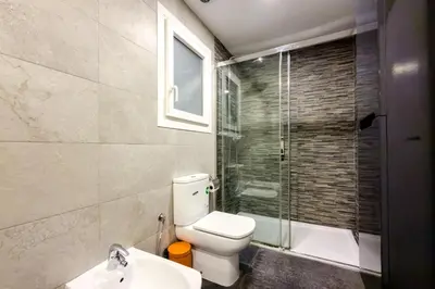 a bathroom with a toilet and a glass shower at Impresionante Apartamento delante del Mar in Vilassar de Mar