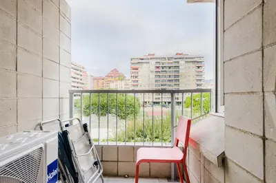 a room with a balcony with a view of a city at Impresionante Apartamento delante del Mar in Vilassar de Mar