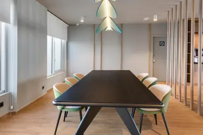 a conference room with a black table and chairs at B&B HOTEL Barcelona Viladecans in Viladecáns