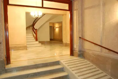 a hallway of a building with stairs and a mirror at Atic Barcelona in Barcelona