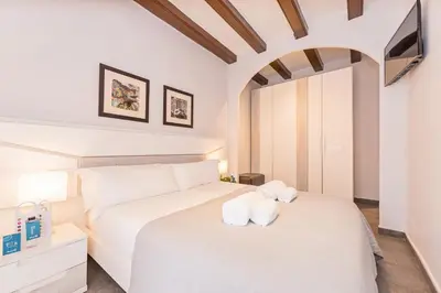 a bedroom with a white bed with towels on it at Sweett - La Villarroel in Barcelona
