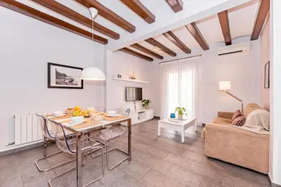 a living room with a table and a couch at Sweett - La Villarroel in Barcelona