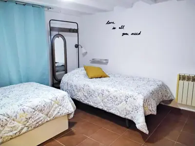 a bedroom with two beds and a mirror on the wall at COLORS FIRA GRAN VIA in Hospitalet de Llobregat
