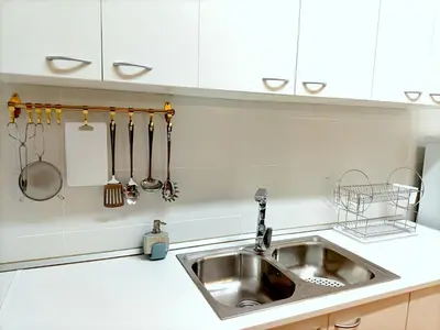 a kitchen with a stainless steel sink and utensils at COLORS FIRA GRAN VIA in Hospitalet de Llobregat
