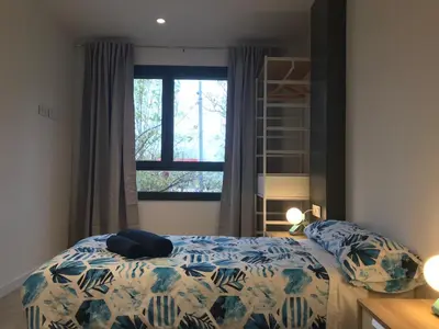 a bedroom with a bed and a window at Llull Home in Sant Adria de Besos