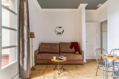 a living room with a couch and a table at Casa Gracia Apartments in Barcelona