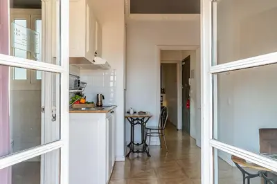 a kitchen with a counter and a table in a room at Casa Gracia Apartments in Barcelona