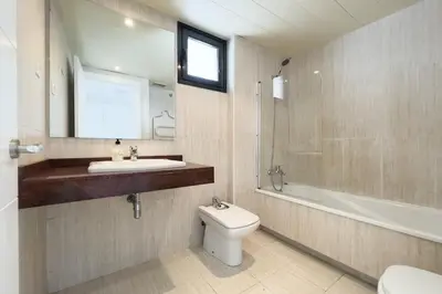 a bathroom with a toilet and a sink and a bath tub at chicStays Apartment Ciutadella Park in Barcelona