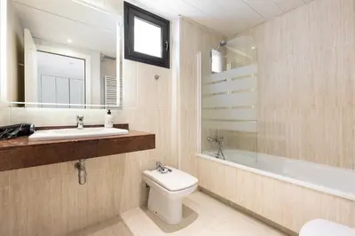 a bathroom with a toilet and a sink and a mirror at chicStays Apartment Ciutadella Park in Barcelona