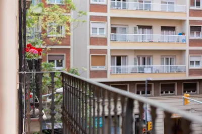 a balcony of a building with flowers on it at ApartEasy - Turo Park with lovely balcony in Barcelona
