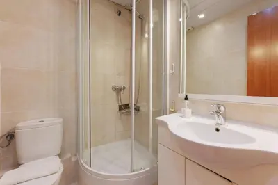 a bathroom with a shower and a toilet and a sink at ApartEasy - Turo Park with lovely balcony in Barcelona
