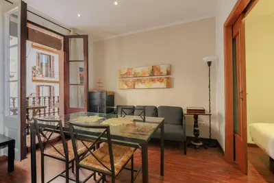 a dining room with a glass table and chairs at ApartEasy - Turo Park with lovely balcony in Barcelona