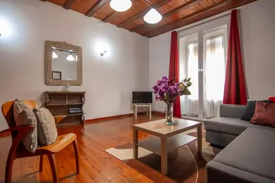 a living room with a couch and a table at Gaudí Ramblas in Barcelona