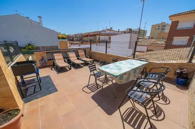 a patio with chairs and a table on a balcony at HomeHolidaysRentals Benoit - Costa Barcelona in Pineda de Mar