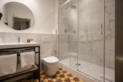 a bathroom with a shower and a toilet and a sink at Fontanella By BCN URBAN Rooms in Barcelona