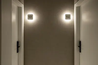 a hallway with two lights on the wall at Fontanella By BCN URBAN Rooms in Barcelona