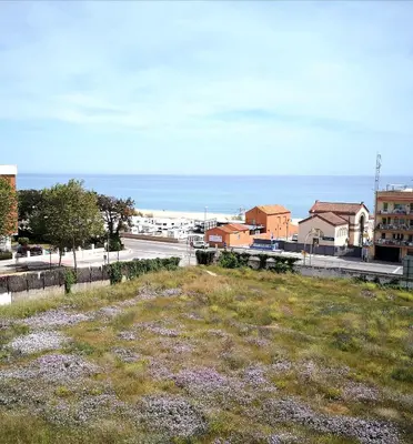 a view of a city with the ocean in the background at ÁTICO FRENTE AL MAR in Canet de Mar
