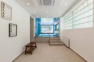a hallway with stairs and a bench in a building at L'aviador de Can Ton in Sant Llorenc Savall
