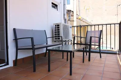 two chairs and a table on a balcony at MonResidence Bellavista in Manresa