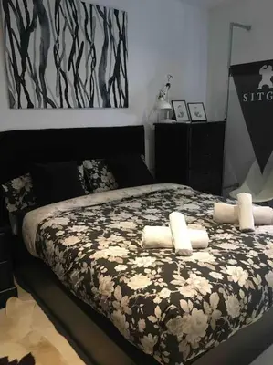 a bedroom with a bed with flowers on it at Sitges in centrum close to the beach in Sitges
