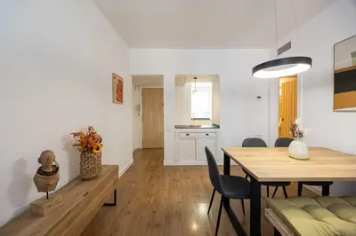 a dining room and kitchen with a table and chairs at Charming 2br In Trendy Gracia in Barcelona