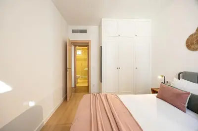 a white bedroom with a bed and a closet at Charming 2br In Trendy Gracia in Barcelona