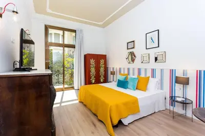 a bedroom with a bed with a yellow blanket at Luxury 4bdr In Gracia in Barcelona