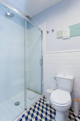 a bathroom with a toilet and a glass shower at Luxury 4bdr In Gracia in Barcelona