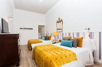 a hotel room with two beds and a television at Luxury 4bdr In Gracia in Barcelona