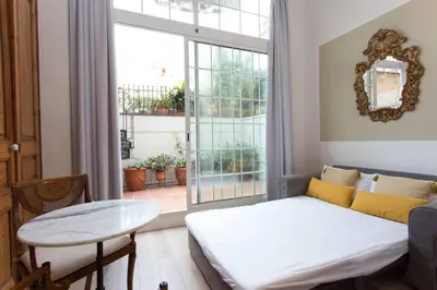 a living room with a bed and a window at Luxury 4bdr In Gracia in Barcelona