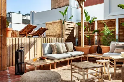 a patio with a couch and tables and chairs at BENI - 1 bedroom apartment with pool and terrace in Gracia in Barcelona