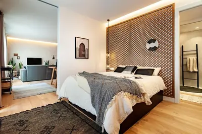 a dining room and living room with a table and a couch at BENI - 1 bedroom apartment with pool and terrace in Gracia in Barcelona