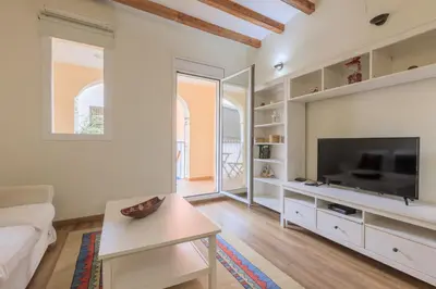 a living room with a flat screen tv and a couch at Housalia Gracia in Barcelona