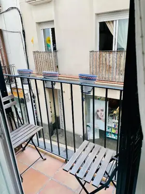 a balcony with two chairs and a railing at Sant Pau Beach Home with terrace in Sitges