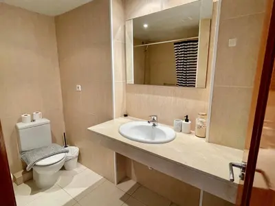 a bathroom with a sink and a toilet and a mirror at Sant Pau Beach Home with terrace in Sitges