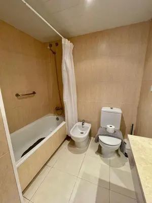 a bathroom with a toilet and a tub and a sink at Sant Pau Beach Home with terrace in Sitges