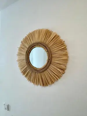 a gold mirror hanging on a white wall at Sant Pau Beach Home with terrace in Sitges