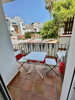 a balcony with a table and chairs on it at Sant Pau Beach Home with terrace in Sitges