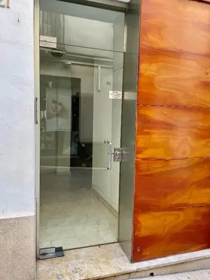 a door to a building with a reflection of a man at Sant Pau Beach Home with terrace in Sitges