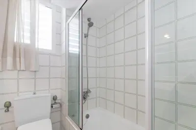 a bathroom with a shower and a toilet at ESTRELLA DE MAR Sitges in Sitges